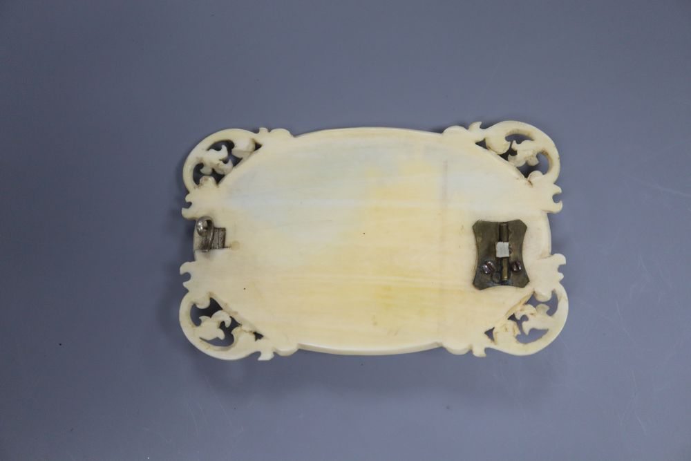 A 19th century Dieppe carved ivory brooch, depicting a hilltop case, 7cms